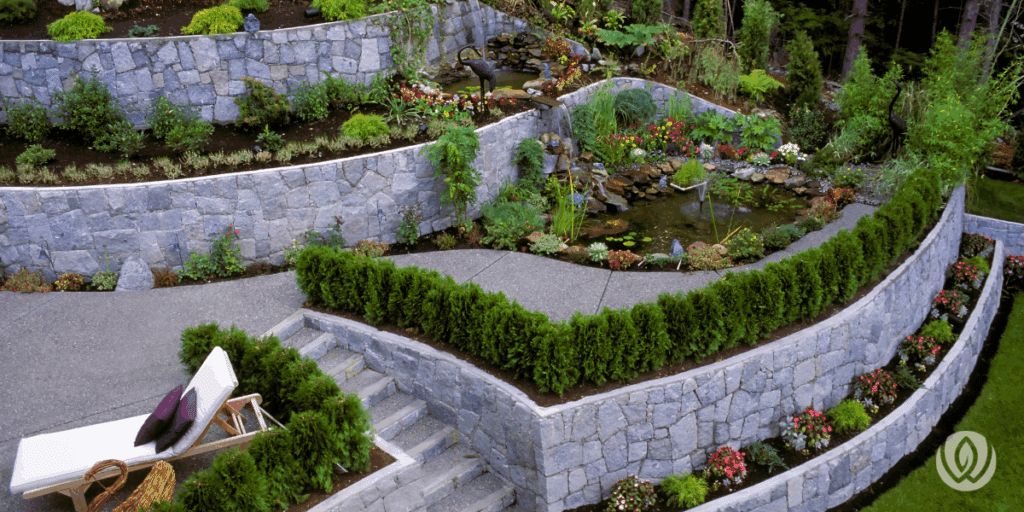 Tiered stone wall supporting elevated garden beds and outdoor furniture