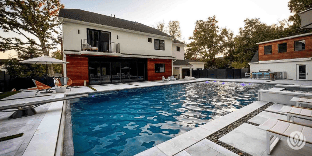 Large custom swimming pool beside a renovated home